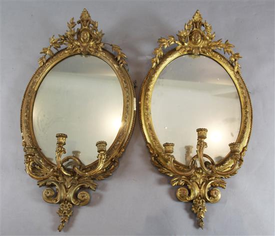 A pair of Victorian gilt gesso three light girandoles, W.1ft 10in. H.3ft 4in.